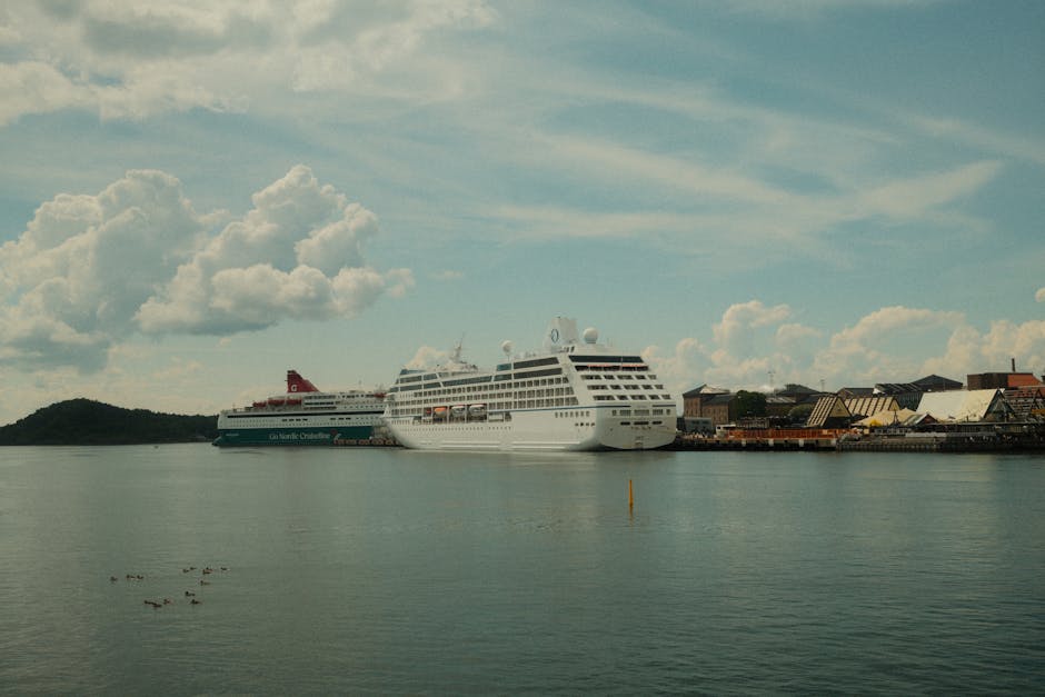 Cruise ships docked at a calm port under a cloudy sky, showcasing travel and leisure. Perfect for marine themes.