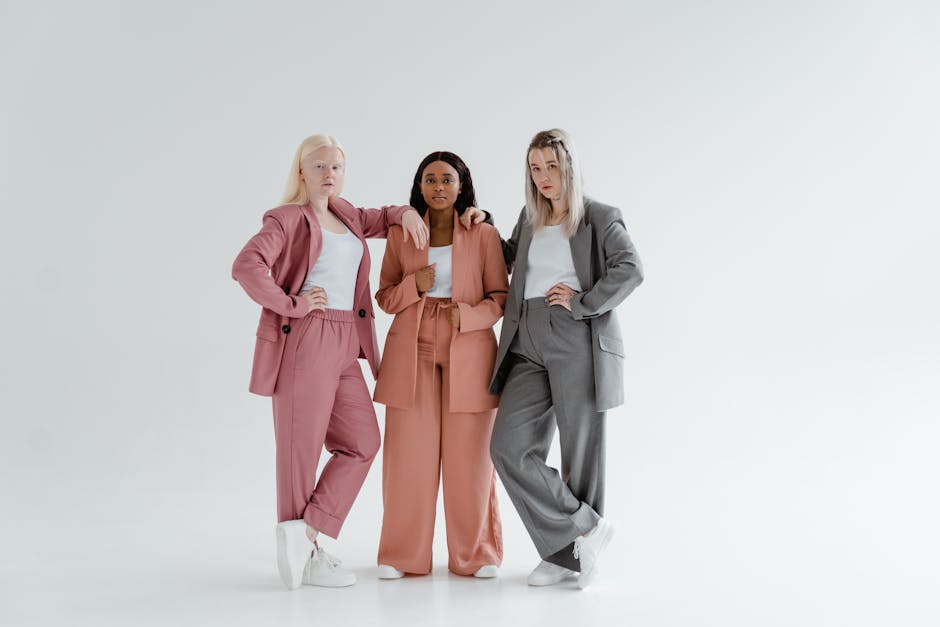 Three women posing in modern business suits highlighting diversity and leadership.