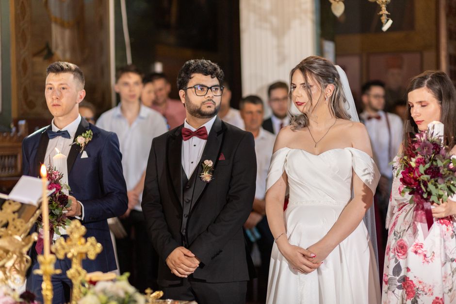 Beautiful wedding ceremony with bride, groom, and guests in formal attire.