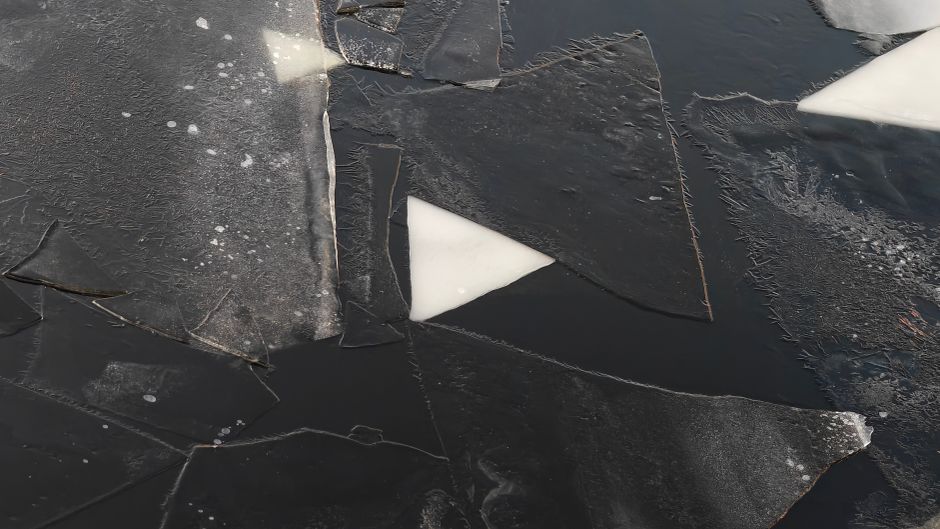 Geometric ice patterns on a frozen surface in Saint Petersburg, Russia.
